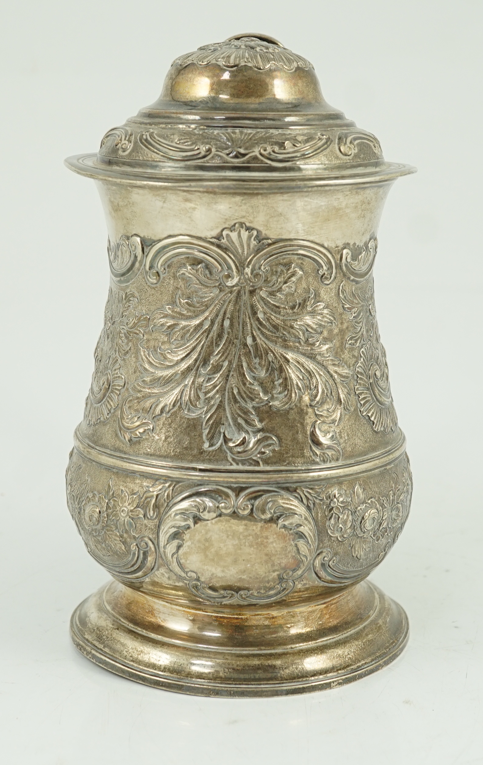 A George II silver baluster tankard, with later embossed decoration, by Robert Albin Cox
